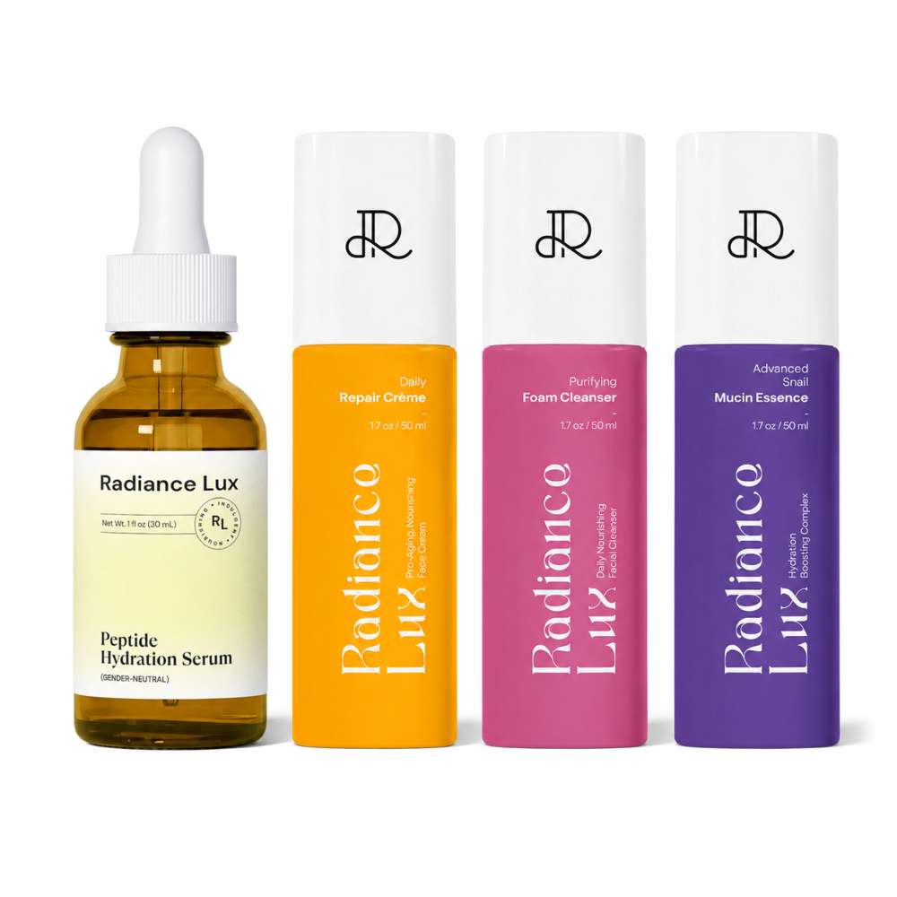 Four Radiance Lux skincare bottles arranged side by side on a white background: a brown glass dropper serum bottle and three cylindrical cleanser/essence bottles in white caps with orange, pink, and purple labels.
